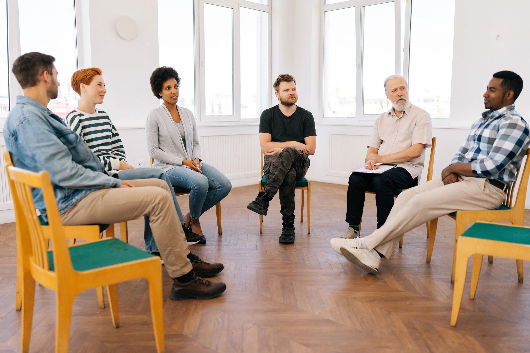 Support group gathered in a circle during a wellness session