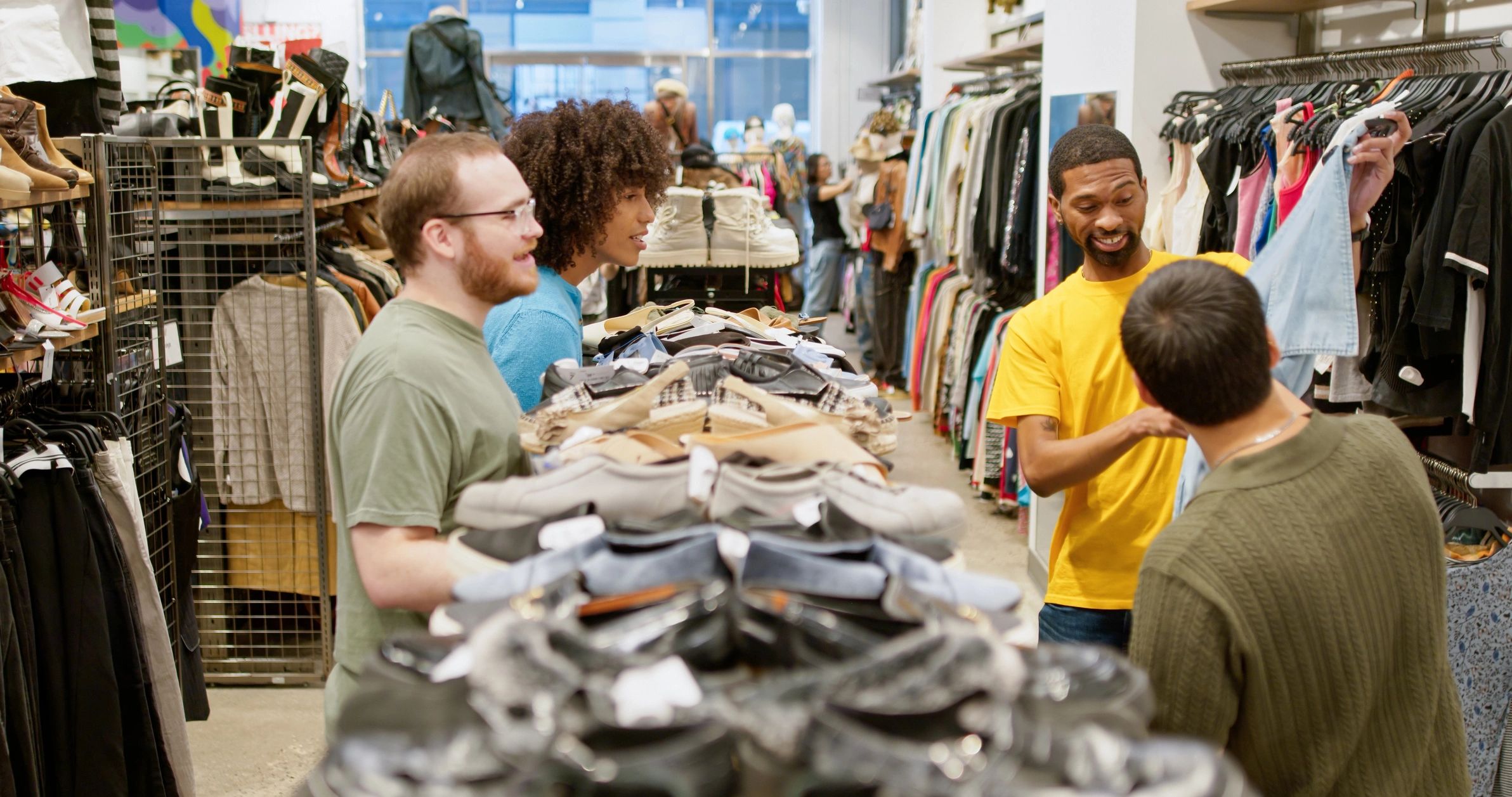 Community members exploring clothing together in a showroom
